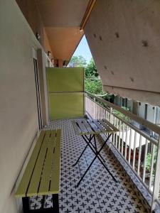 a balcony with a green bench on a balcony at Kookoo in Athens