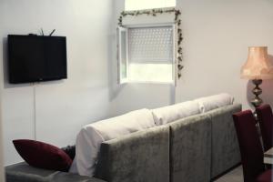 a living room with a couch and a television at Casa la Serrana in Yecla