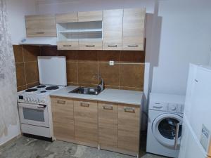 a small kitchen with a sink and a stove at Barreira Beachfront Rooms 3 in Kalamata