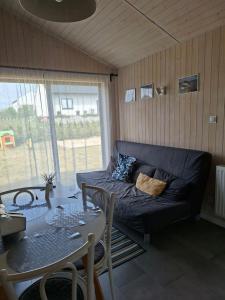 a living room with a couch and a table at Perła Szotlandu II in Władysławowo