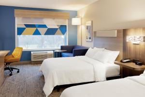 a hotel room with two beds and a desk at Holiday Inn Express Hotel & Suites Cleveland-Streetsboro by IHG in Streetsboro