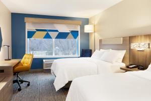 a hotel room with two beds and a window at Holiday Inn Express Hotel & Suites Cleveland-Streetsboro by IHG in Streetsboro