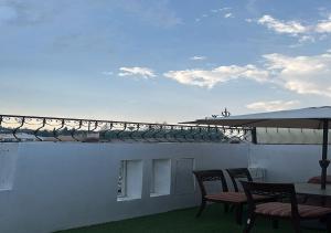 a patio with chairs and a table on a roof at فندق نسيم أبها in Abha