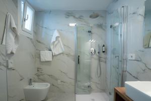 a bathroom with a shower and a toilet and a sink at Hotel Berna in Eraclea Mare
