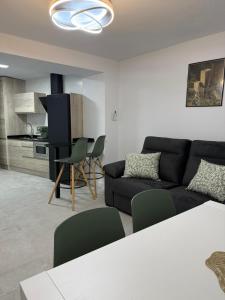 a living room with a couch and a table at Alojamiento Jacuzzi Las Ruinas in Cazorla