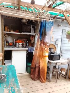 a kitchen with a table and a kitchen with a tent at D'Ici ou D'ailleurs in Barneville-Carteret