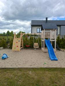 a playground with a slide and a swing set at Perła Szotlandu II in Władysławowo