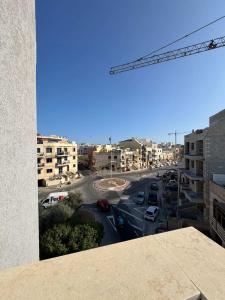 a view of a city street with a crane at Spacious Stay 2 Bed with Terrace - by HostMT in Fgura