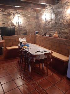 a kitchen with a table and chairs in a room at Medulillas in Yeres +9 photos