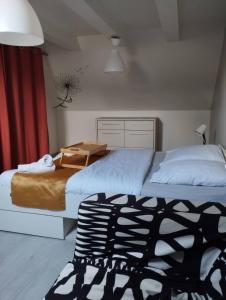 a bedroom with two beds and a chair in it at Grande maison BREST in Brest +55 photos