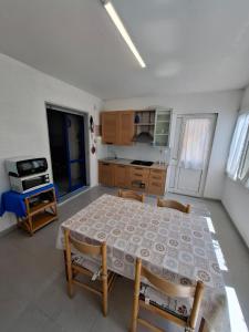 a kitchen with a table and chairs in a room at La casa del delfino in Policoro +5 photos