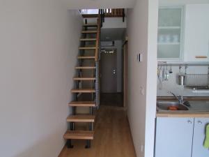 a staircase in a small room with a kitchen at Apartment Iris in Bohinj