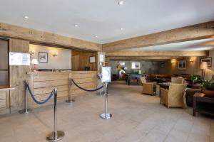 a lobby of a hotel with tables and chairs at Residence Albane - maeva Home in Vars