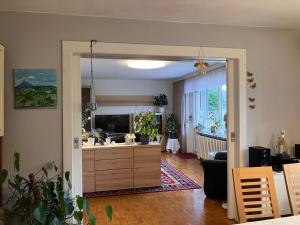 a living room with a television and a living room with a couch at Ferienwohnung Hans in Girbigsdorf +8 photos