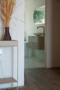 a bathroom with a sink and a vase at The Countryhouse - Retreat with Pool & SeaView in Rethymno Town +31 photos