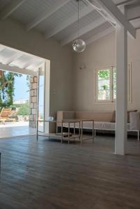 a living room with a bed and a table at The Countryhouse - Retreat with Pool & SeaView in Rethymno Town