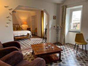a living room with a couch and a coffee table at Les Dames de Saint Florent in Saint-Florent-sur-Auzonnet +44 photos