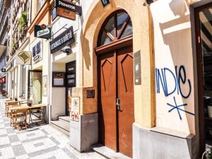 a door on a building with graffiti on it at Angel room with large terrace R6 in Prague +7 photos