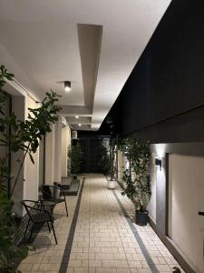 a hallway with chairs and plants in a building at New Times Stay in Bucharest