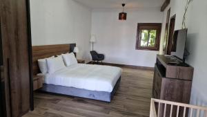 A bed or beds in a room at Hôtel Mandy