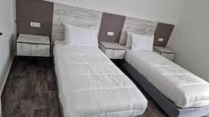 A bed or beds in a room at Hôtel Mandy