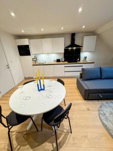 a living room with a table with candles on it at Chic & Modern 1BR & 1LR Apt, 12 Min Walk to Rabot in Ghent