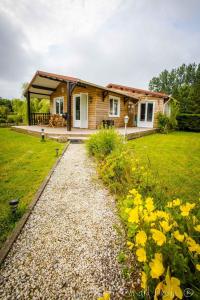 a house with a gravel path in front of it at Le Chalet Cavronnais in Cavron-Saint-Martin