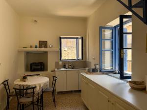 a kitchen with a table and a table and chairs at iris house in Kalo Chorio