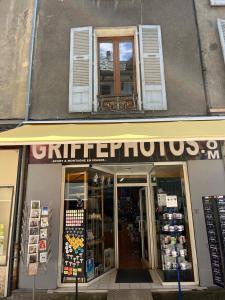 a store with a sign on the front of a building at Appartement centre ville de Bourg d'Oisans in Le Bourg-dʼOisans