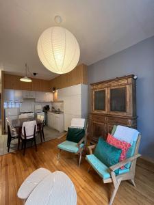 a living room with chairs and a dining room at Appartement centre ville de Bourg d'Oisans in Le Bourg-dʼOisans
