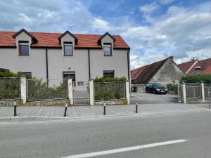 a white house with a red roof on a street at Smart Stay Apartment Samobor in Samobor