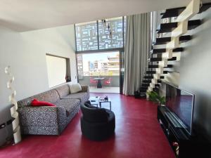a living room with a couch and a tv at Athina Art Apartments in Athens