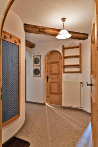 an empty hallway with a door and a window at Chesa Grischuna 4pax - Madulain in Madulain