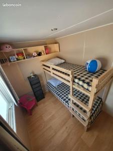 a small room with two bunk beds in it at Mobil home, camping les pins maritimes in Hyères