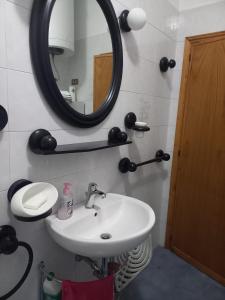 a bathroom with a sink and a mirror at Vacanze da Susy Casa Silvana in Passignano sul Trasimeno