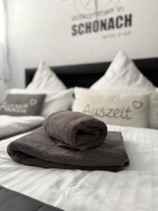 a pile of towels sitting on top of a bed at Appartement zur Birke in Obertal