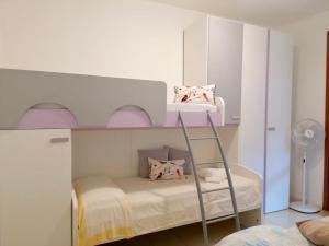 a white bunk bed with a ladder in a room at Sulla spiaggia di Letojanni in Letojanni