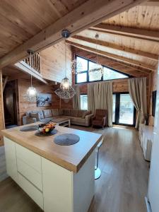 a kitchen and living room in a log cabin at Villa Butterfly Valdanos in Ulcinj +20 photos