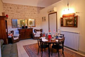 a living room with a wooden table and chairs at Casa Catalé in Modica
