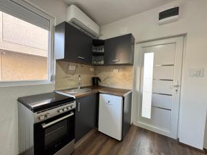 a small kitchen with a sink and a stove at Teona Apartment in Ohrid +2 photos