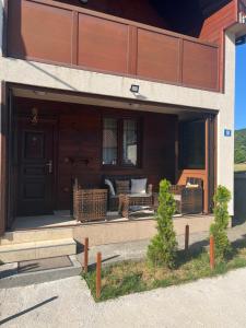 a front door of a house with a couch on it at Vila&Apartments Helena in Kolašin
