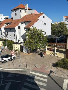 a car parked in a parking lot next to a building at Delta Marina Vilamoura in Quarteira