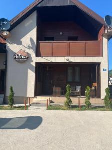 a building with a sign on the side of it at Vila&Apartments Helena in Kolašin