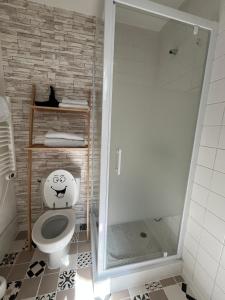 a bathroom with a toilet with a smiley face drawn on it at Grand studio rdc au calme, centre ville prox Cathédrale in Orléans +5 photos