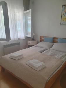 a bedroom with two beds with towels on them at Apartman Relax Čelebići in Konjic +47 photos