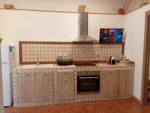 a kitchen with a sink and a stove top oven at Rifugio nel borgo in Monasterace