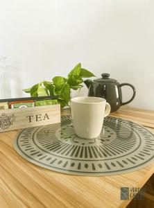 a tea cup sitting on a plate on a table at Verdincanto Relax e comfort a due passi dal centro in Lucca