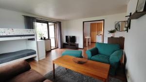 a living room with a couch and a table at Lägenhet i Skärhamn nära hav och natur! in Skärhamn