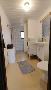 a bathroom with a sink and a washing machine at Lägenhet i Skärhamn nära hav och natur! in Skärhamn +25 photos
