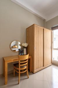 a dining room with a wooden table and a mirror at Urban Stay Saigon Dictrict 4 in Ho Chi Minh City